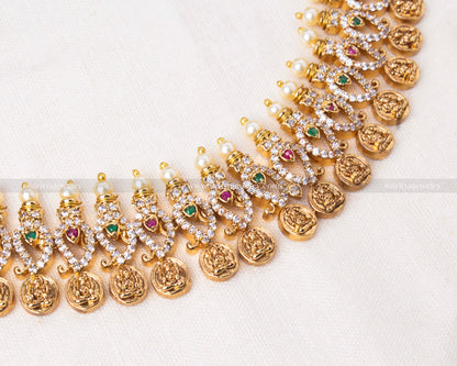 Traditional temple coin necklace adorned with pearls and multicolored gemstones, perfect for weddings and festive occasions.