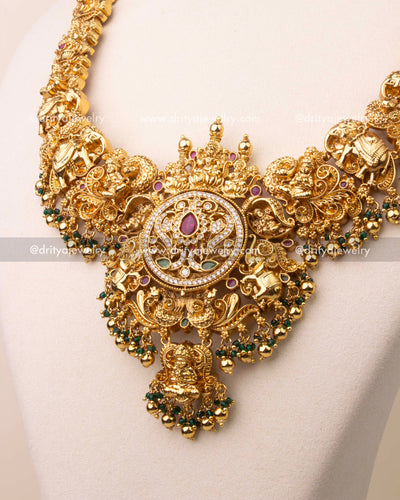 Reversible pendant showing floral pattern with ruby centerpiece and CZ stones