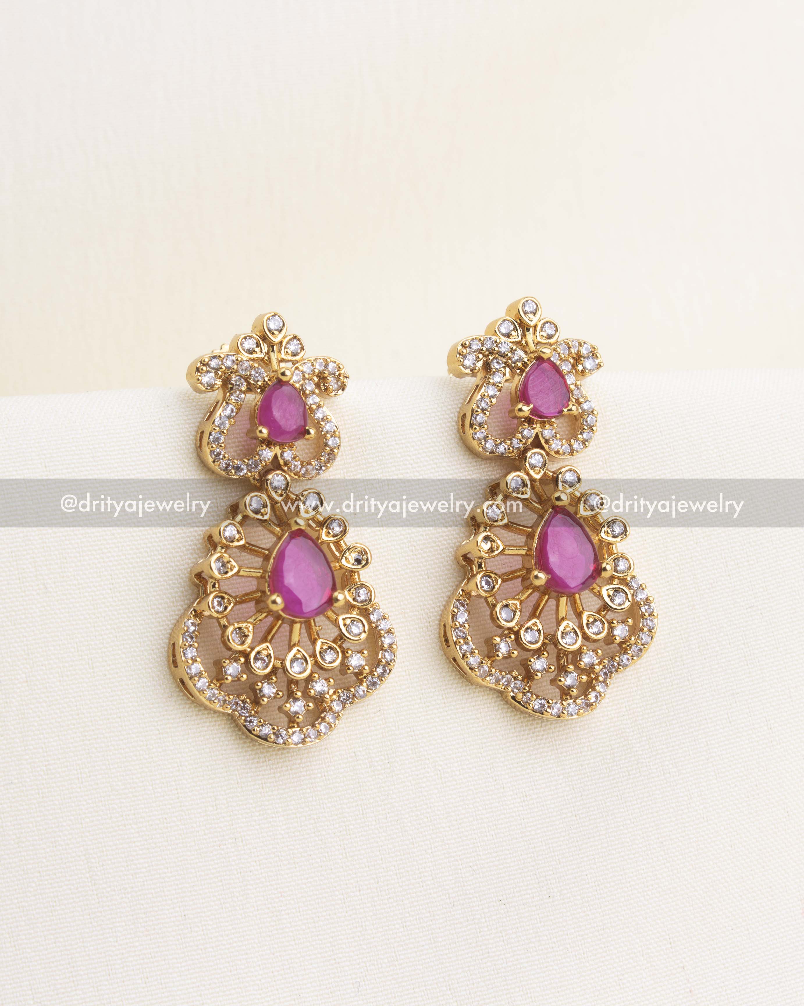 Matching ruby earrings with teardrop stones and sparkling CZ detailing