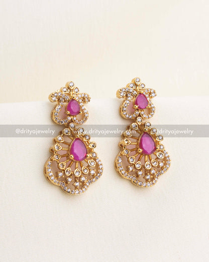 Matching ruby earrings with teardrop stones and sparkling CZ detailing