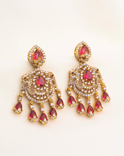 Ruby red chandelier earrings with CZ setting and teardrop design in gold-plated finish.