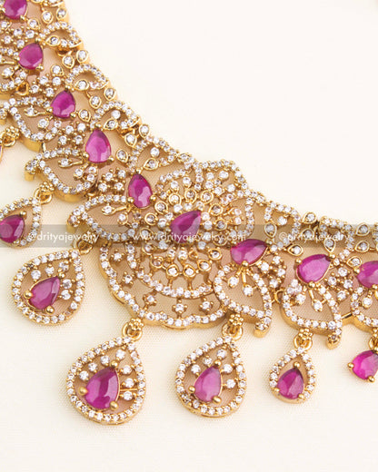 Close-up of ruby centerpiece with intricate CZ framework and pear-shaped hangings