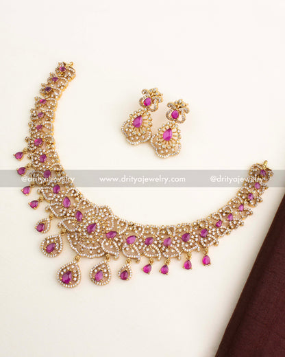 Short necklace set with ruby pear-shaped stones, gold finish, CZ layering, and matching earrings