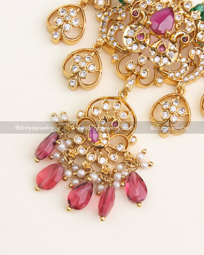 Close-up of premium ruby necklace featuring pink teardrop beads, green stone accents, and detailed AD floral motifs.