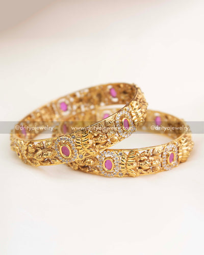 Close-up showing ruby pink centerpiece, halo of AD stones, and intricate temple goddess artwork
