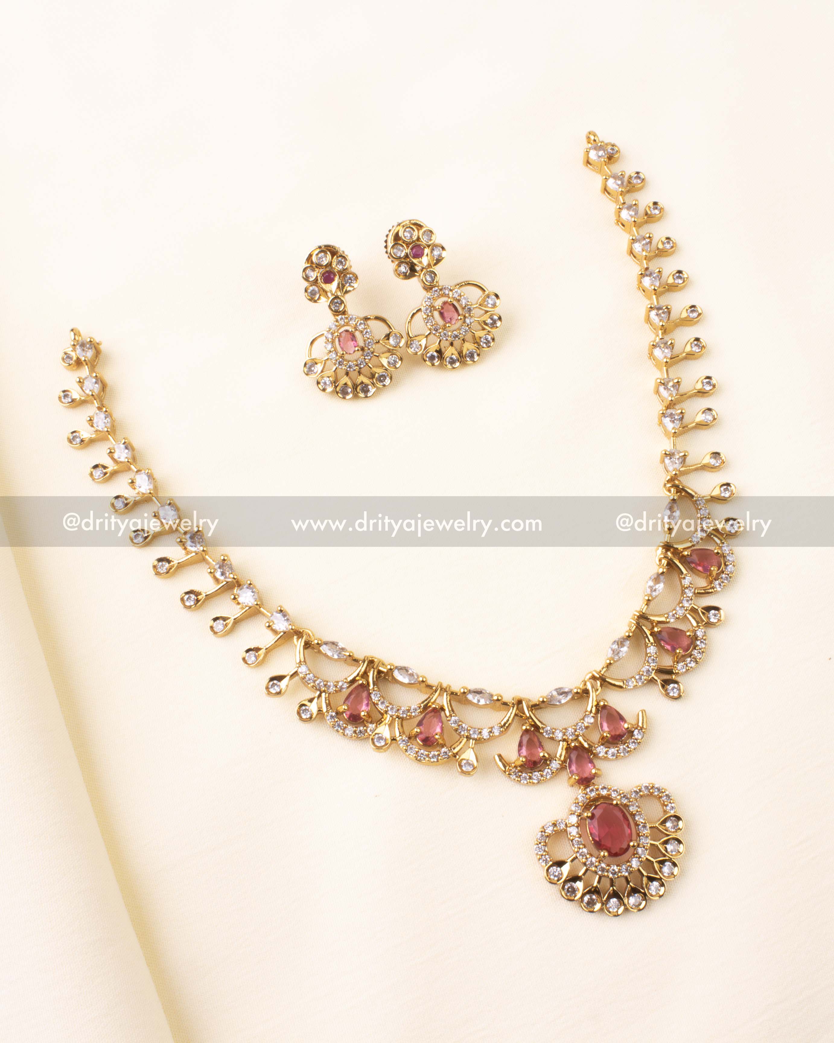 Gold-toned CZ necklace set with ruby red stones and fixed pendant