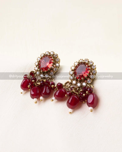 Matching earrings with red center stones and bead tassels