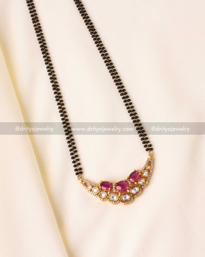 Elegant black beads necklace with ruby-red moissanite stones and kundan detailing, perfect for weddings and festivals.