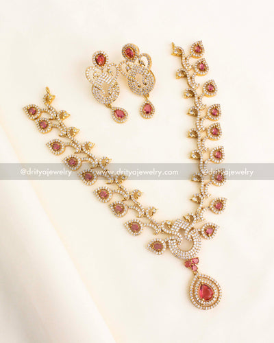 Short necklace set with ruby red and CZ stones in a leaf and teardrop design, gold finish.