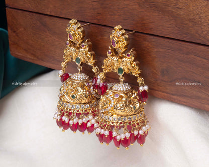 Detailed view of the ruby red Radiant Gemstone Jhumka Earrings, showcasing the vibrant gemstones and elegant pearl finish.