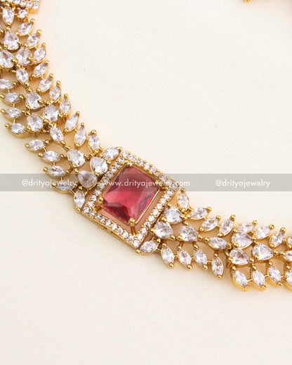Detailed close-up of ruby red centerpiece surrounded by micro CZ stones.