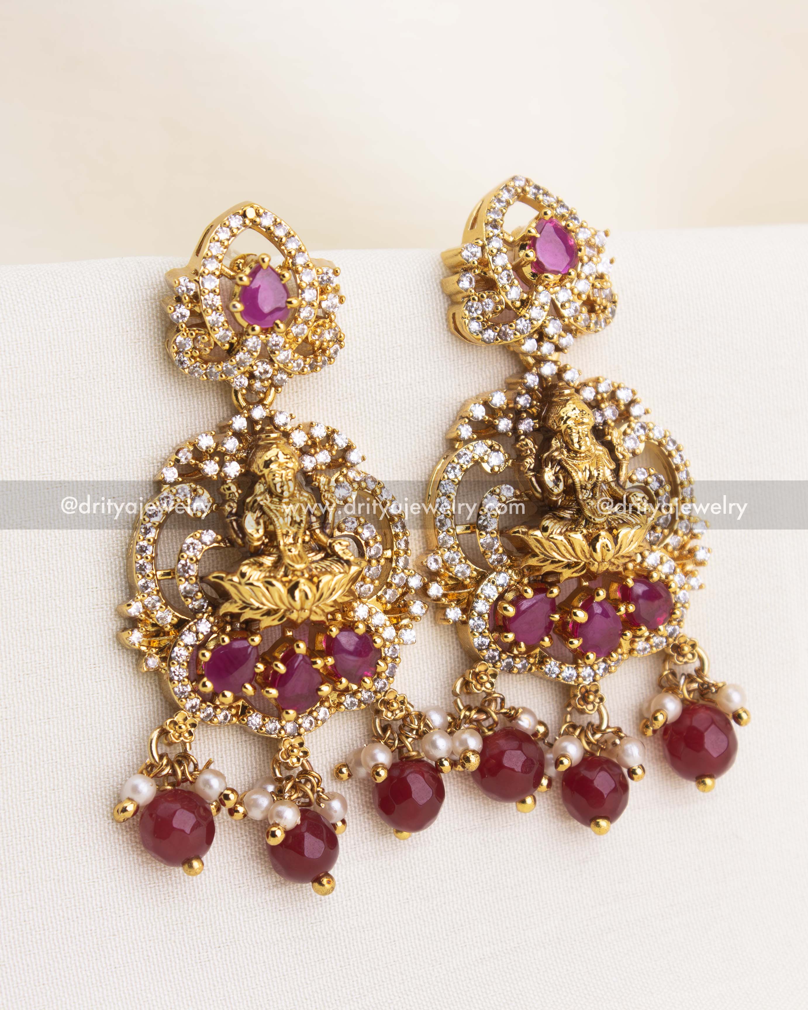 Traditional temple danglers with Lakshmi motif, ruby stones, and pearl bead drops.