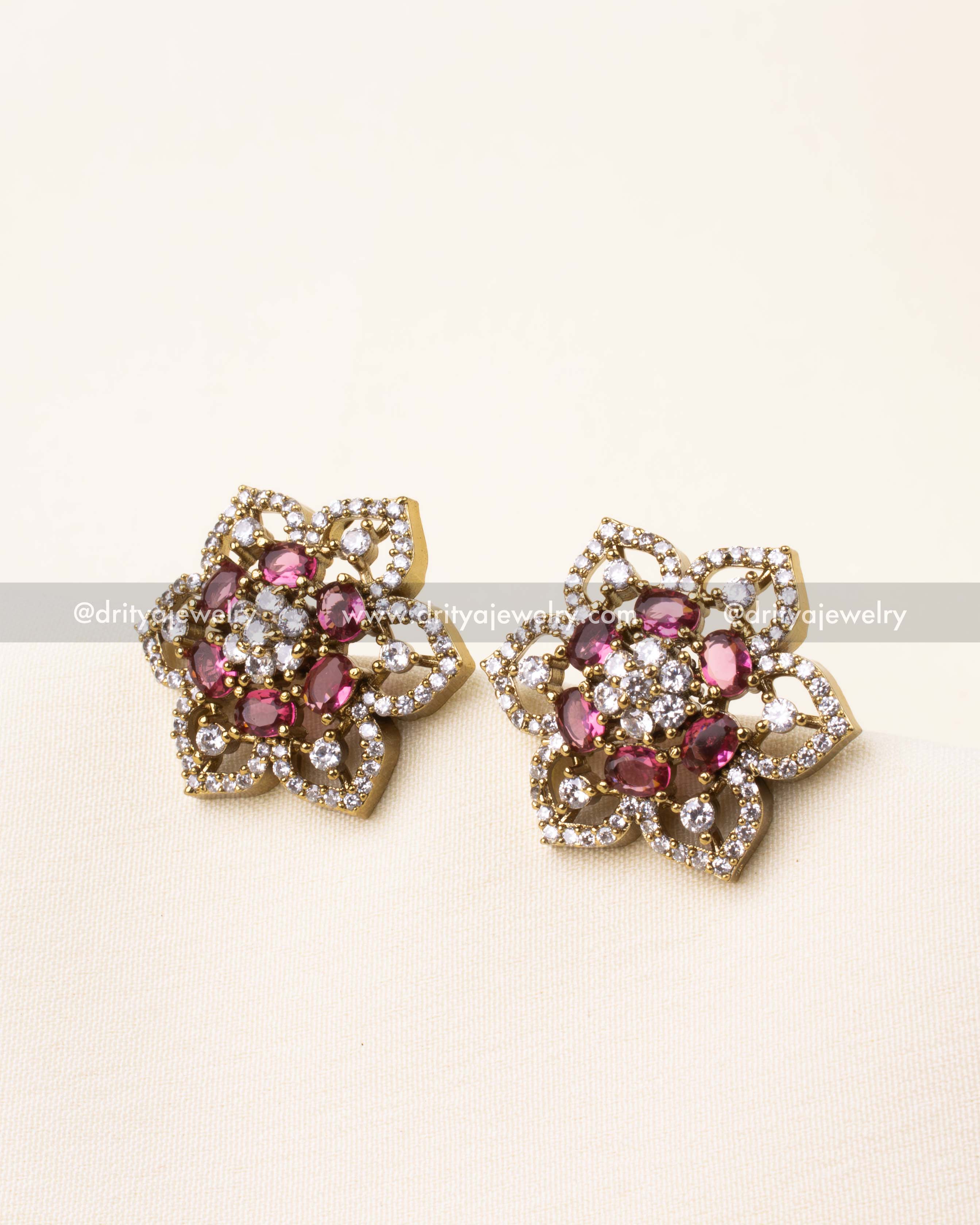 Detailed view of Victorian polish CZ studs featuring ruby red stones.