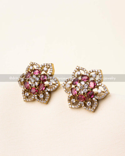 Detailed view of Victorian polish CZ studs featuring ruby red stones.