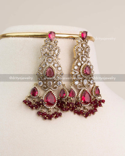 Large Victorian-style bridal danglers with ruby red teardrop stones and white CZ detailing.