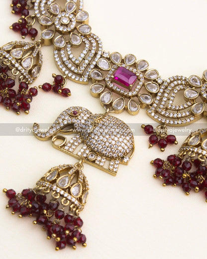 Close-up of ruby Victorian short necklace featuring elephant motif, floral patterns, and CZ detailing.