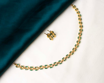 Stylish short necklace set featuring pink AD stones and a gold-tone finish.