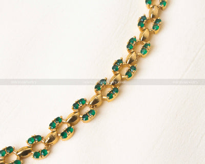 Stylish short necklace set featuring pink AD stones and a gold-tone finish.