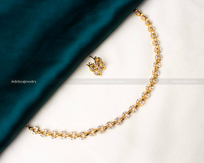 Elegant short necklace set adorned with white AD stones and matching earrings.