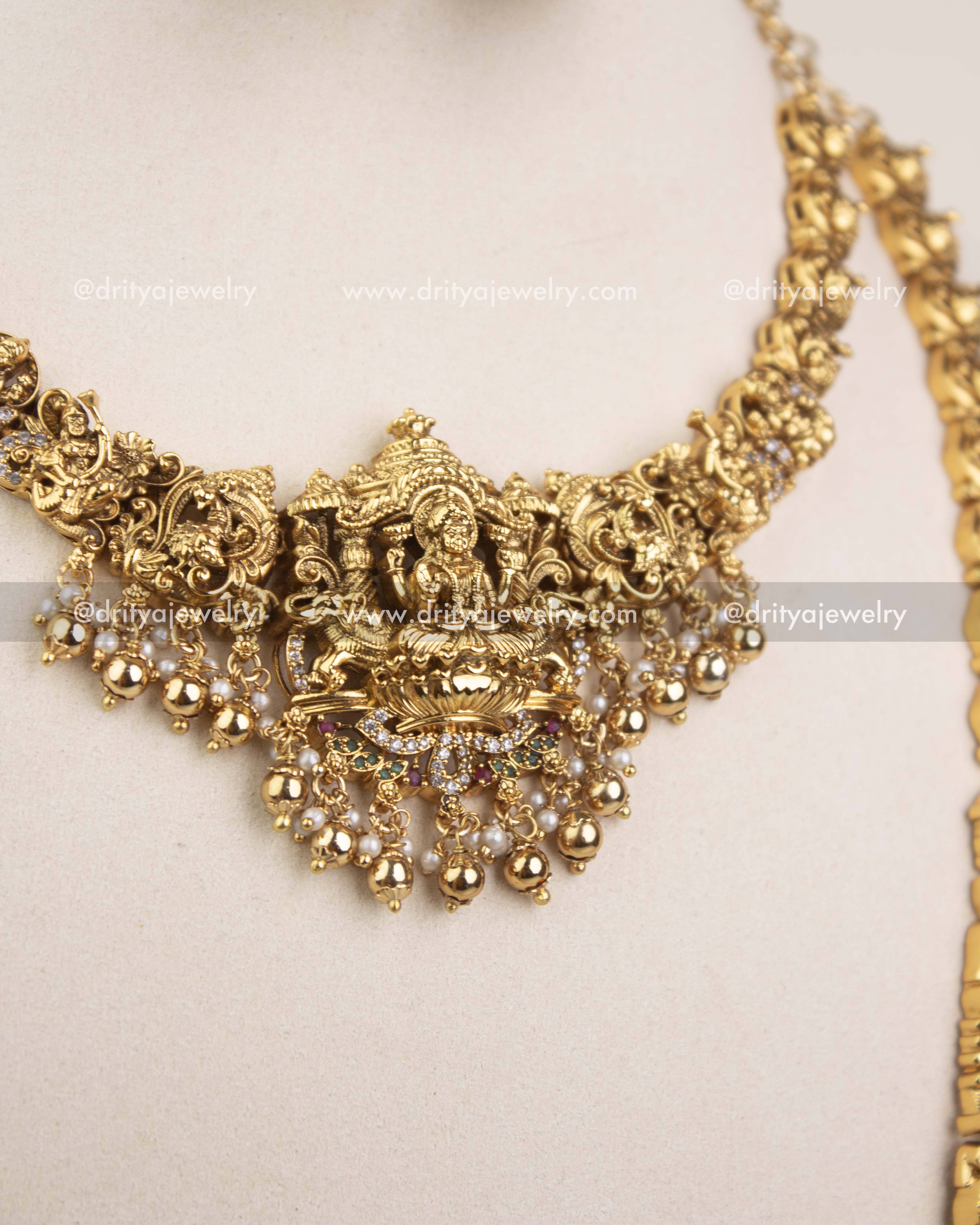 Close-up of short necklace Lakshmi pendant with pearls and gold detailing