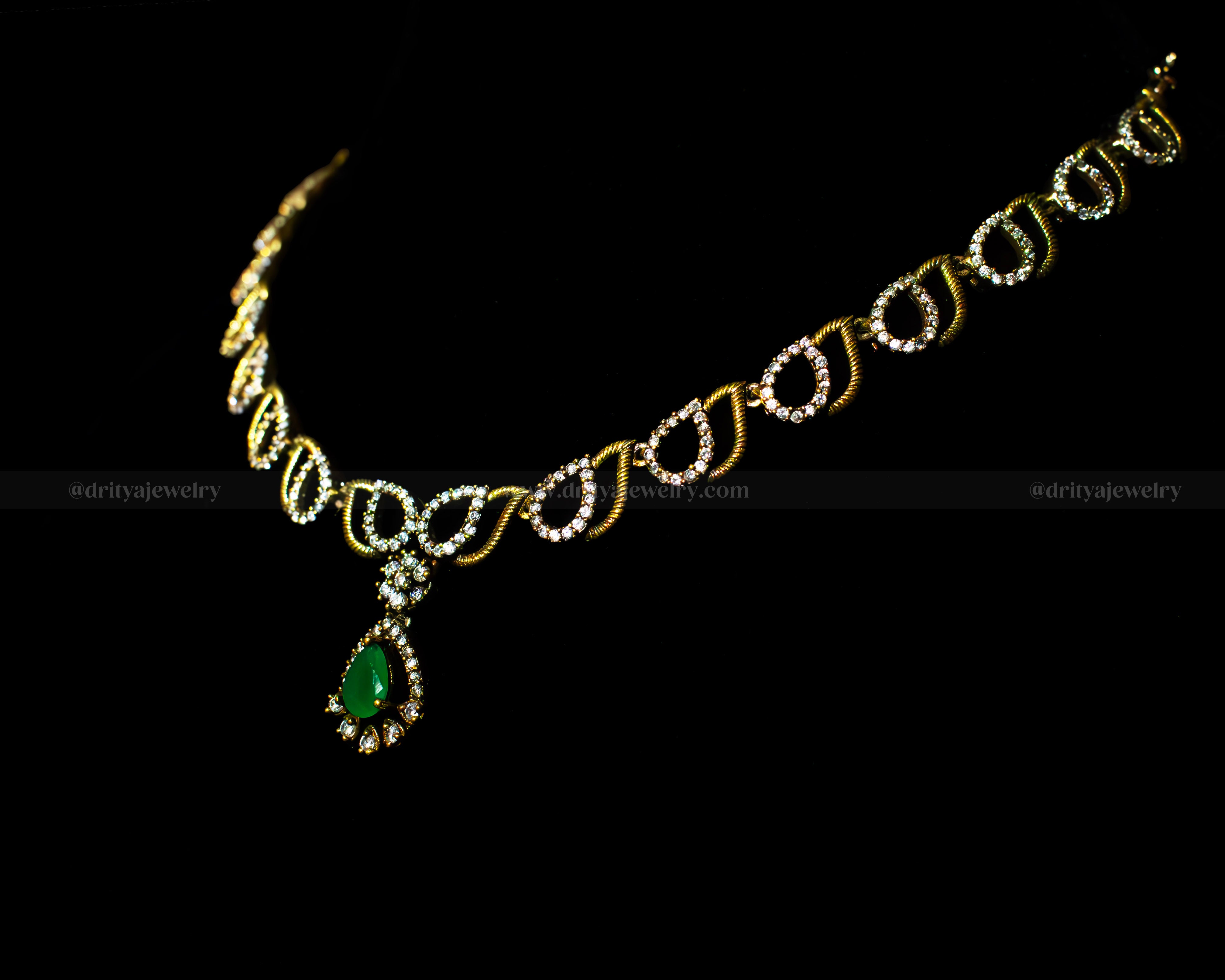 Side angle of the Dritya Jewelry Mehndi Victorian Necklace showcasing its intricate teardrop chain design and green gemstone pendant.