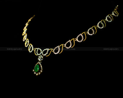 Side angle of the Dritya Jewelry Mehndi Victorian Necklace showcasing its intricate teardrop chain design and green gemstone pendant.