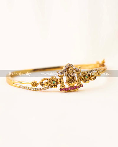 Gold-plated openable kada with Lakshmi Devi idol and CZ stones.
