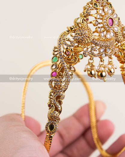 Intricate side design of Ara Vanki with peacock and floral patterns set with CZ stones.