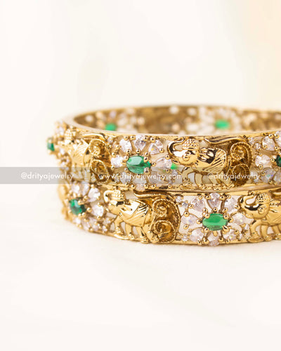Premium bangles with elephant carvings, emerald accents, and high-quality CZ detailing.