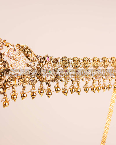 Side profile of the antique gold Nakshi waist belt showcasing detailed carvings and polki stone embellishments.
