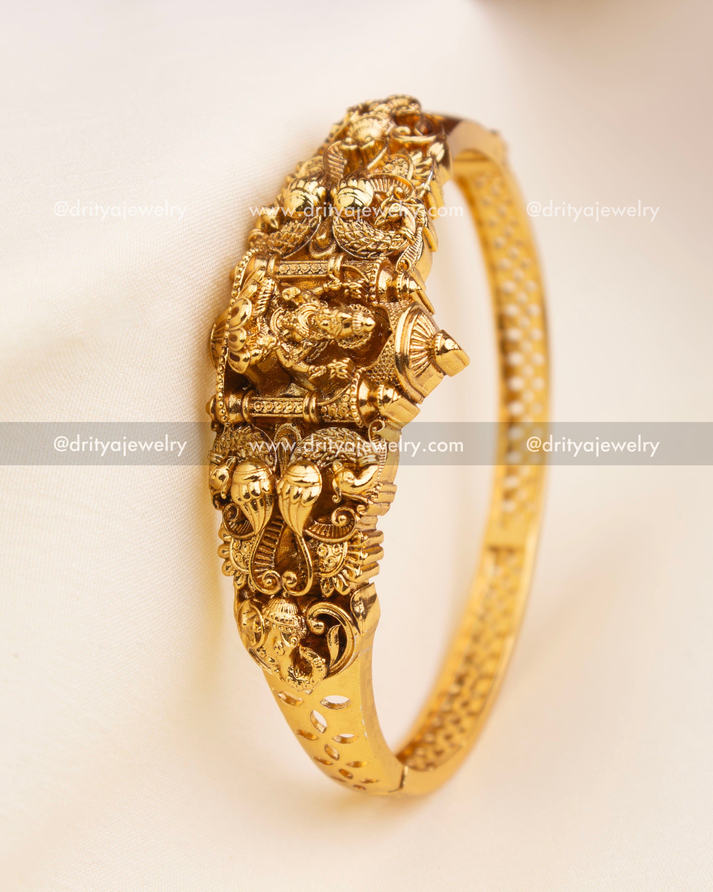 Angled view of openable kada featuring side cutwork design and traditional Nakshi carving.