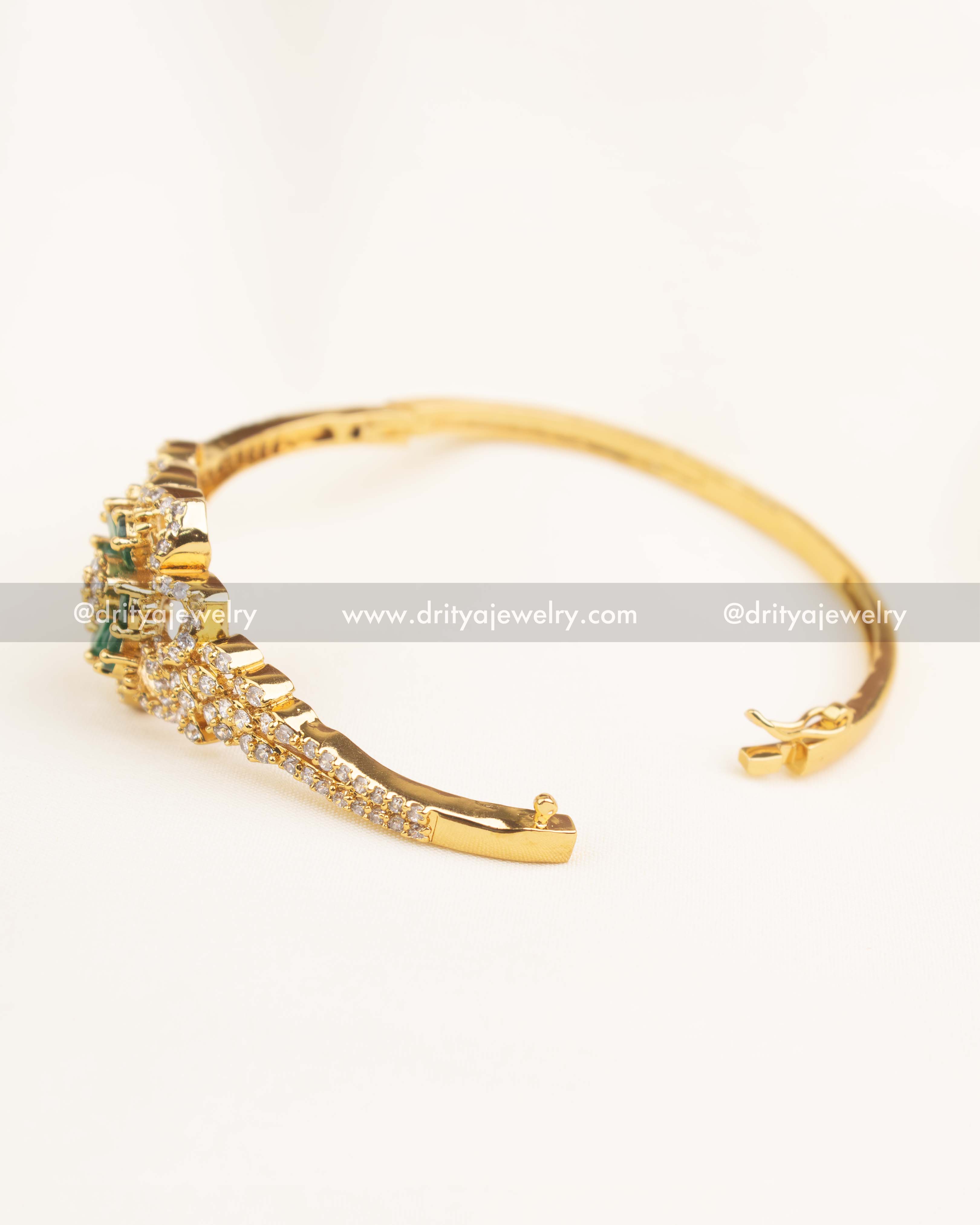 Elegant side-angle view of green floral CZ kada with intricate gold detailing.