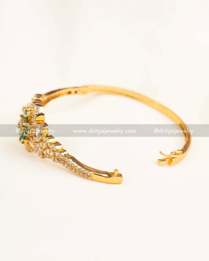 Elegant side-angle view of green floral CZ kada with intricate gold detailing.