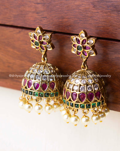 Victorian polish jhumkas with ruby and green stones, CZ accents, and pearl drops.