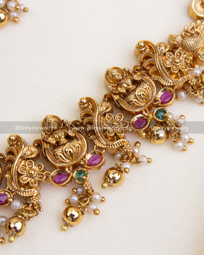 Ornate Lakshmi and floral design on a temple necklace with traditional finishing.