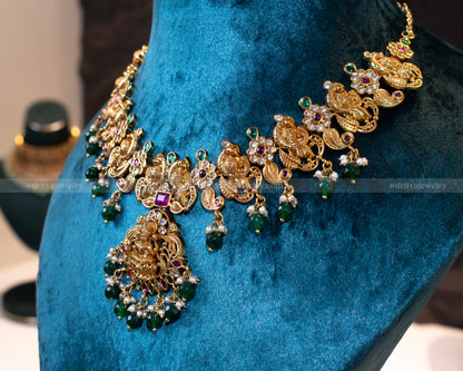 Side view of Dritya Jewelry's Temple Necklace Set with green beads, showcasing the detailed craftsmanship of the peacock motifs and Lakshmi pendant.