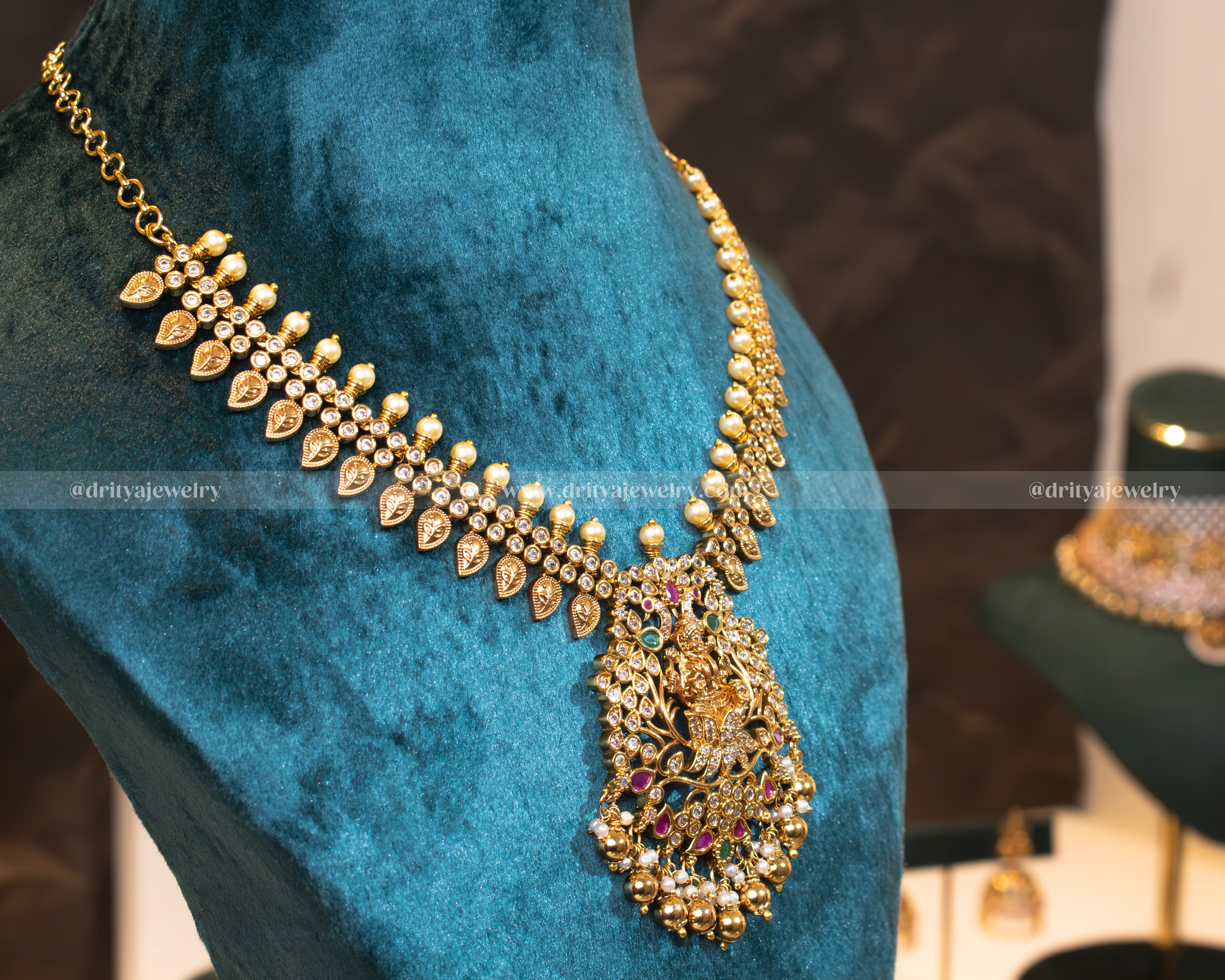 Side view of the temple necklace set showcasing the divine Lakshmi motif and detailed gold-toned embellishments by Dritya Jewelry.