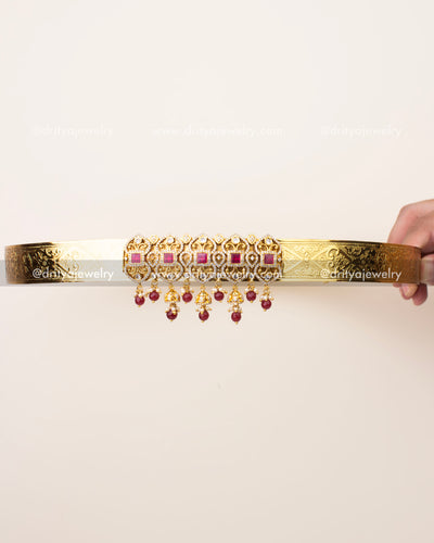 Simple gold finish vaddanam with CZ motifs and ruby bead hanging design
