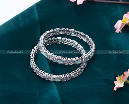 A stack of Mint Green CZ Bangles by Dritya Jewelry, perfect for versatile styling options.