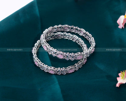 A stack of Pink CZ Bangles by Dritya Jewelry, perfect for versatile styling options.