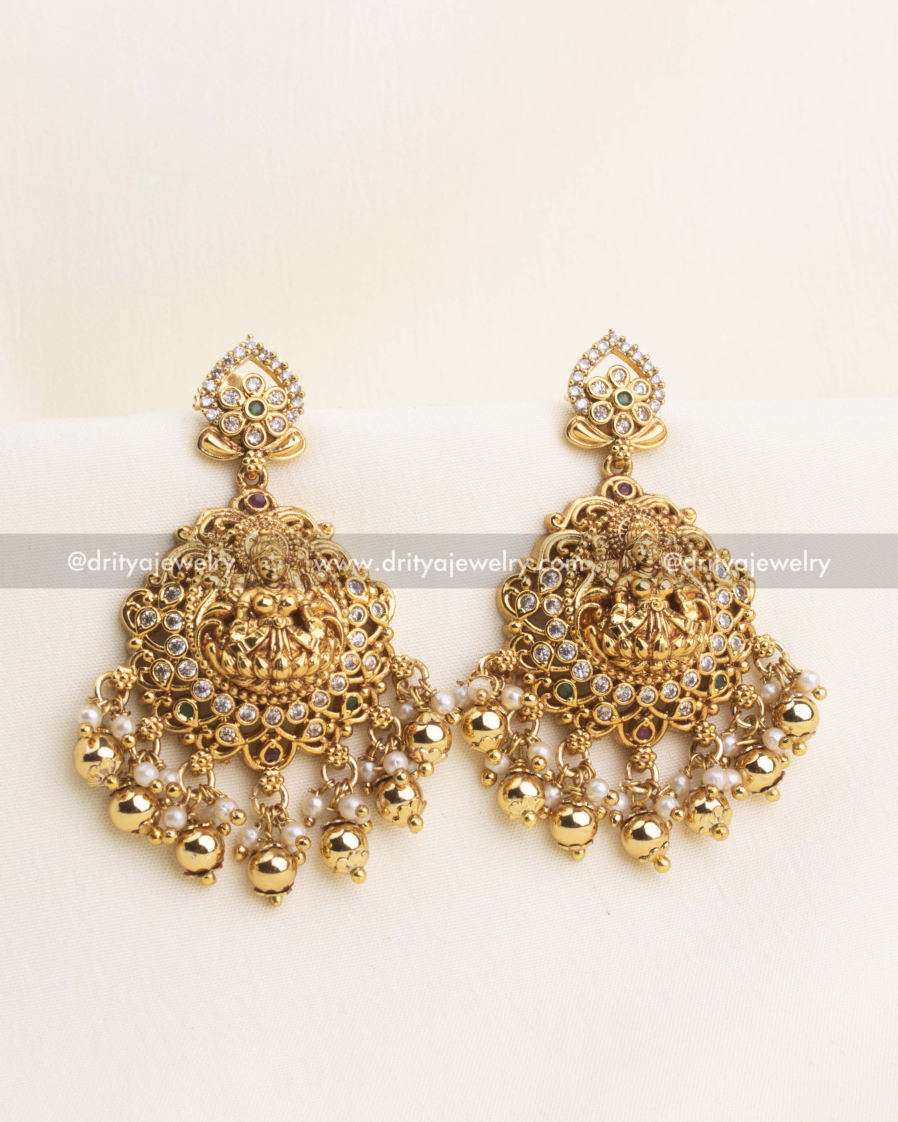 Traditional temple-style Dangler earrings with Lakshmi motif, pearls, and antique gold finish.