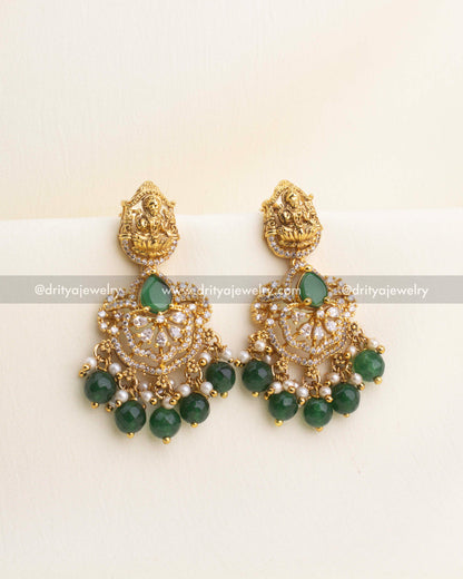 Gold temple earrings with nakshi Lakshmi tops, CZ stone work, and emerald green bead drops.