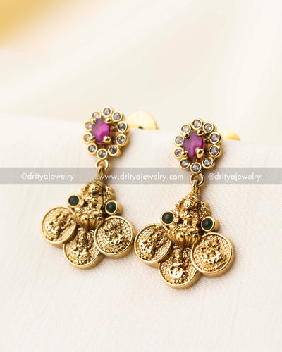 Traditional earrings featuring Lakshmi motifs with ruby stone tops and coin danglers.