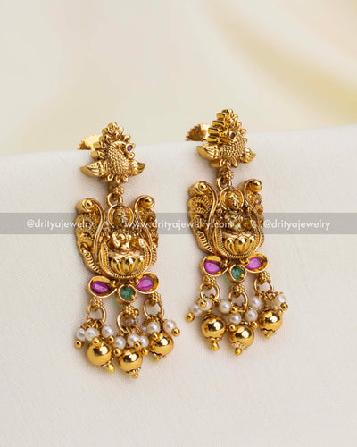 Matching temple earrings featuring goddess motifs, colorful accents, pearls, and golden beads.