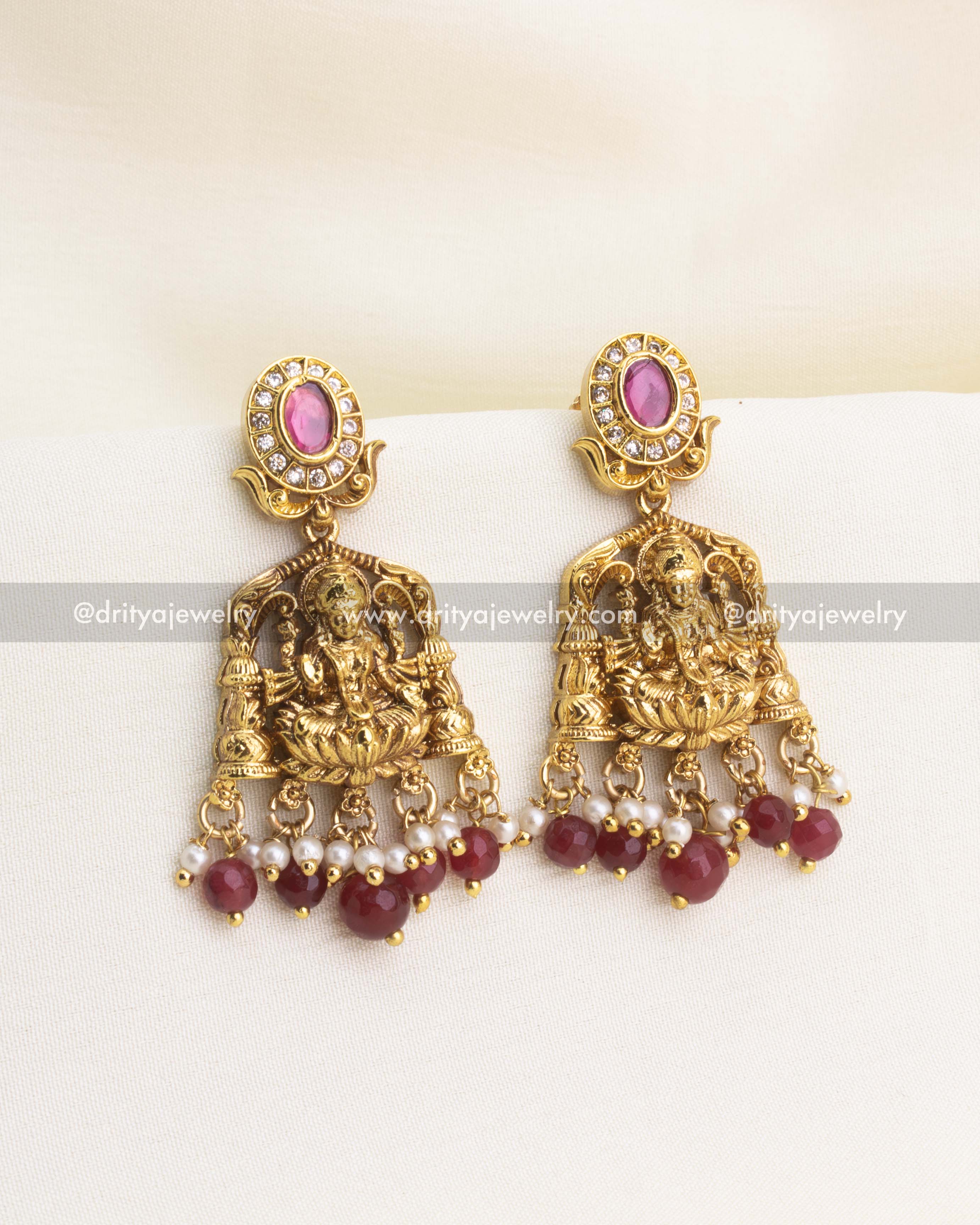 Matching ruby bead earrings with Lakshmi carvings and CZ detailing.
