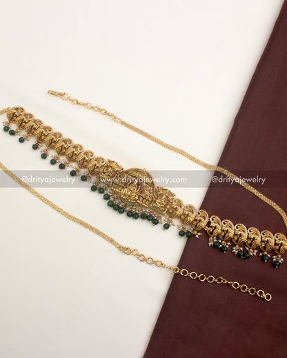 Premium temple-style hip chain with nakshi peacock motifs and emerald green bead hangings.