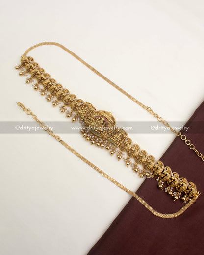 Antique temple waist belt with gold ball hangings and intricate nakshi peacock detailing.