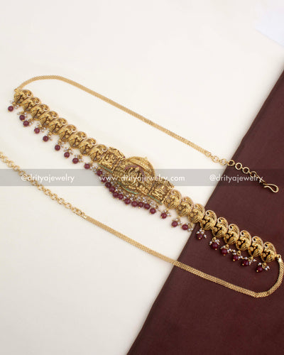 Premium nakshi temple hip belt with ruby red bead hangings and peacock motifs.
