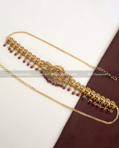 Premium nakshi temple hip belt with ruby red bead hangings and peacock motifs.