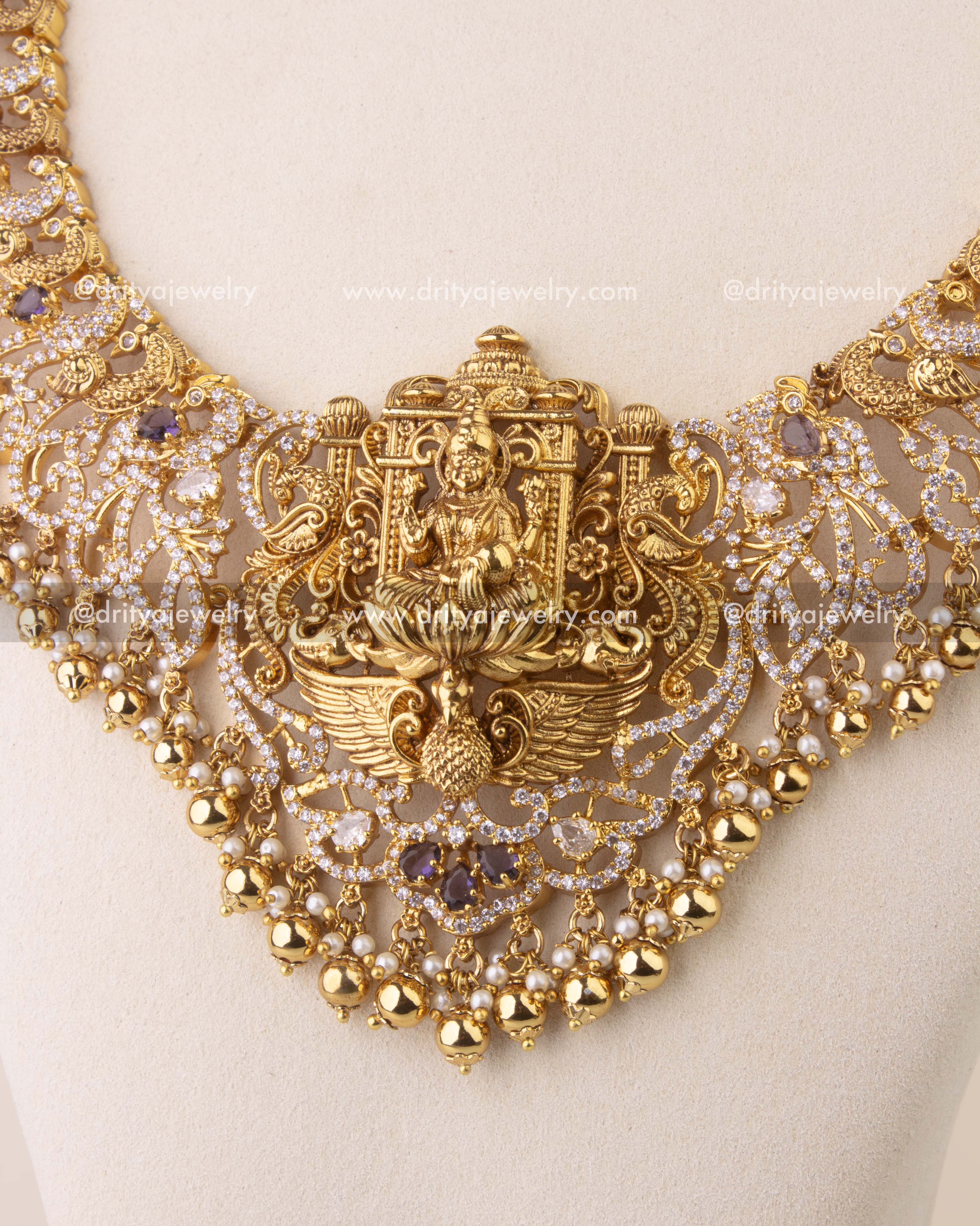 Close-up of temple-style Nakshi necklace with intricate peacock motifs and gold bead accents.